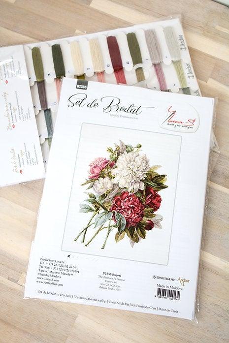 Piones B2355L Counted Cross-Stitch Kit featuring colorful threads, canvas, and needle for crafting.